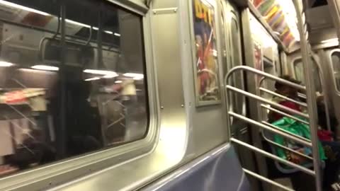 Woman sings loudly in subway train, recorder laughs