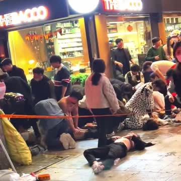 Dozens of people receive CPR in the streets of Seoul.