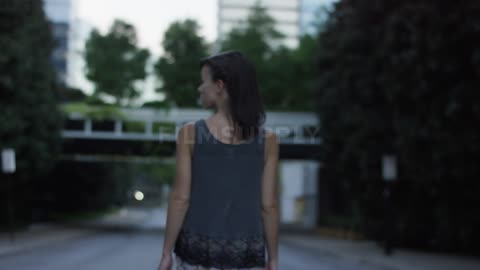 A woman walks down a street in the daytime