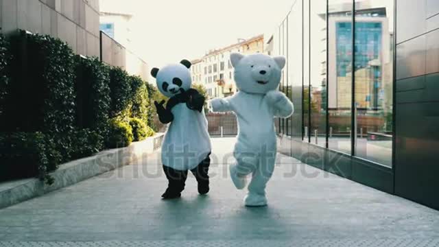 Couple of friends dancing inside big animal costumes