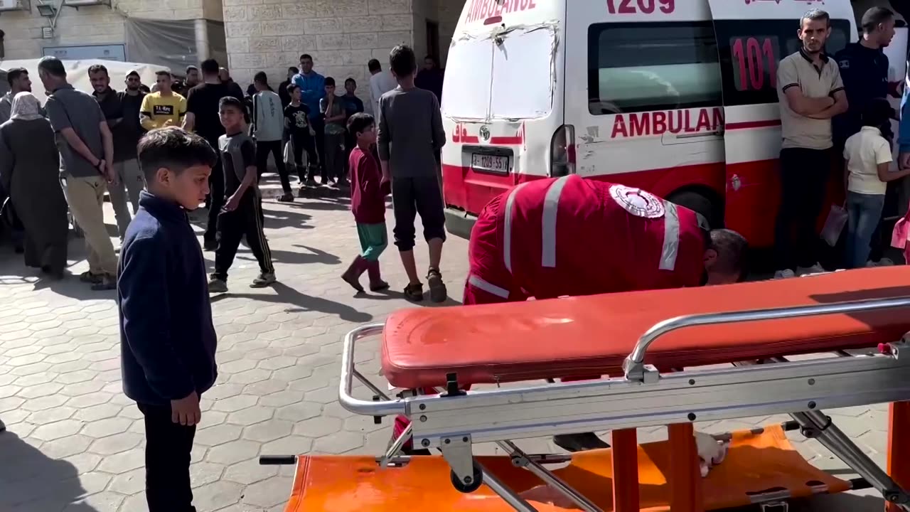 A Gazan boy helps medics at Al-Aqsa hospital