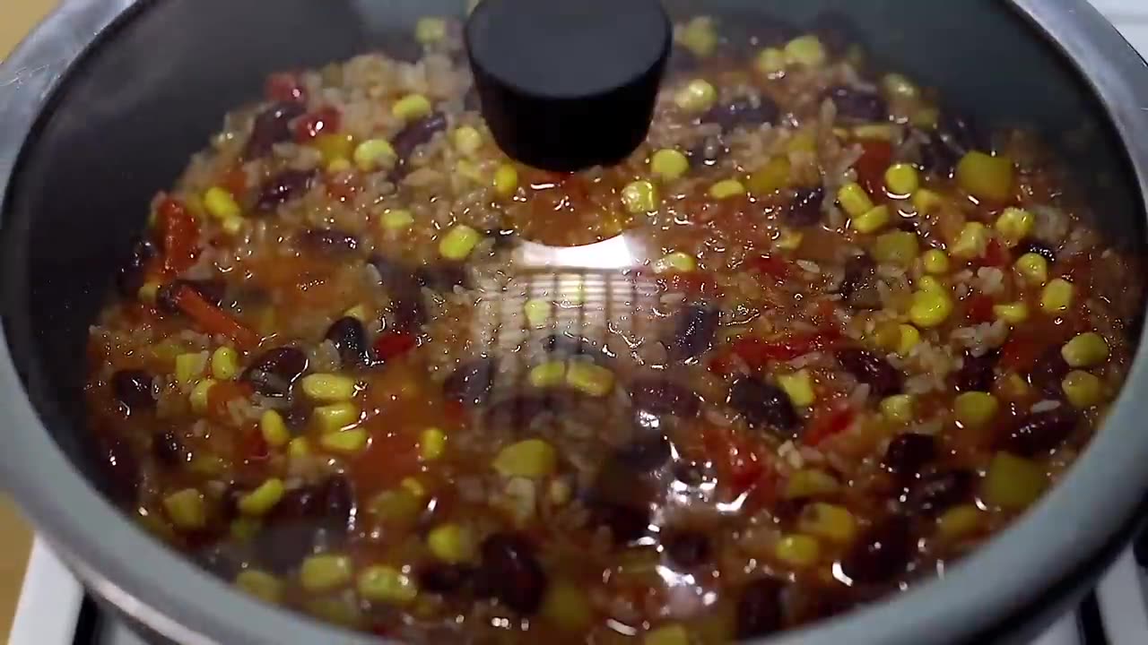 A very simple and delicious dinner! Rice with vegetables in a frying pan.