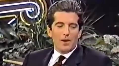 JFK Jr. reads a poem written by Monica Lewinsky, where she creatively describes herself as a pizza.