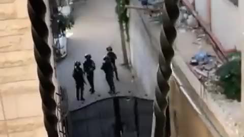 An Israeli soldier fires at a little girl for looking out of a window.