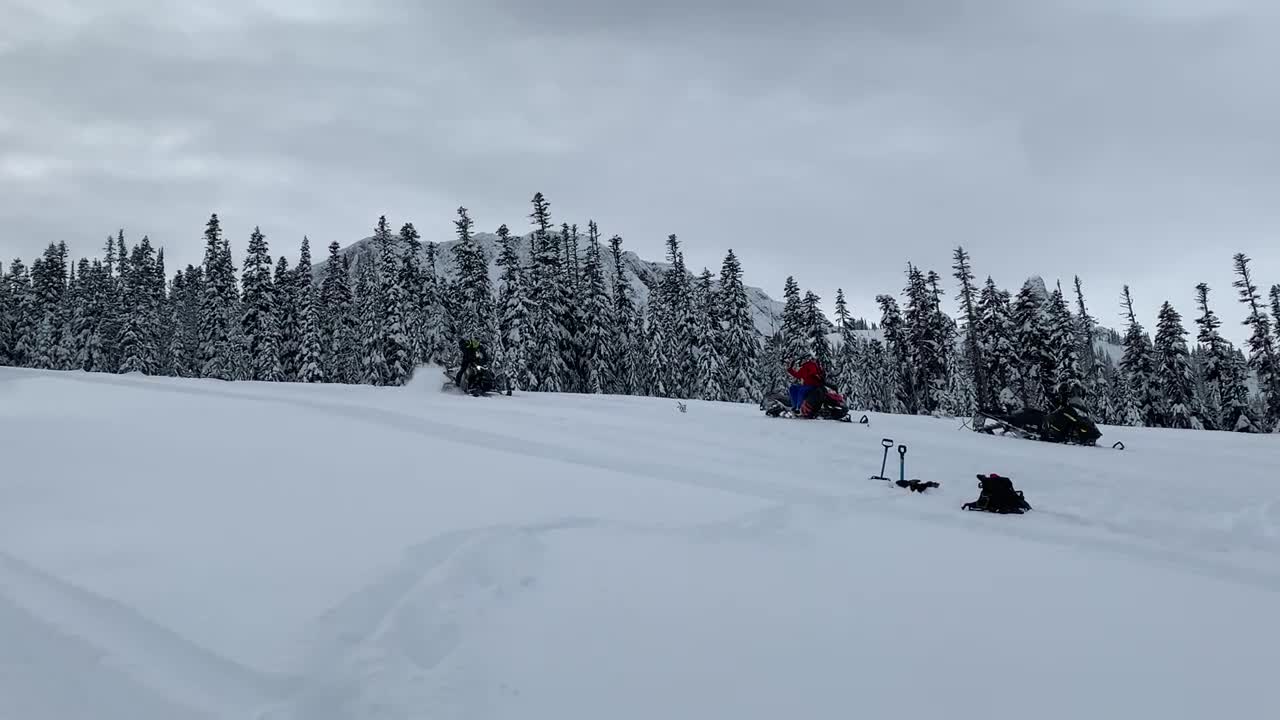 Guy Gets Thrown Off A Snowmobile When It Flips As He Drives Downhill