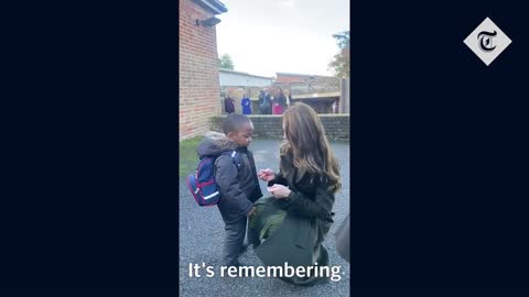 11_Princess Kate gives remembrance poppy to young boy during school visit