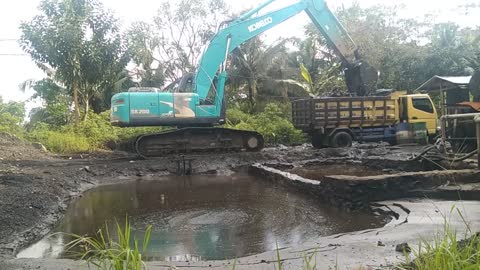 Heavy equipment excavator is digging mud