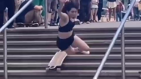 chick tries to stairbash large set of stairs on her skateboard, doesn't end well