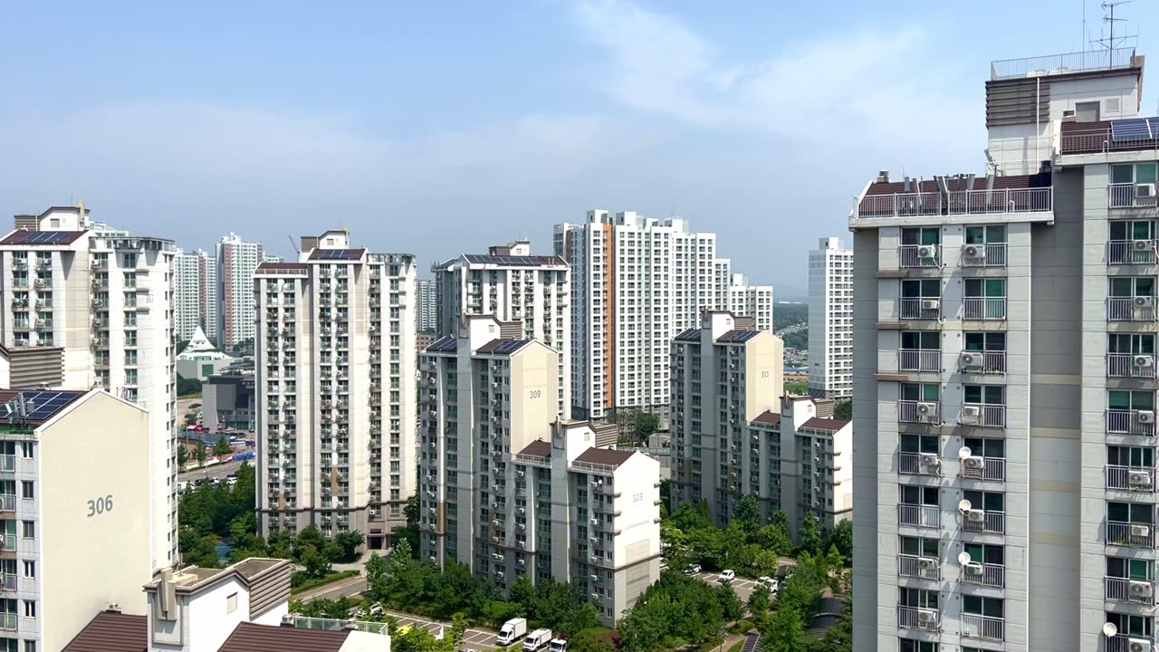 a residential complex with clear skies and high-rise apartments