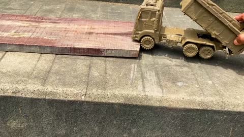Drive the Muddy Toy Vehicle by hand and threw it into the water for cleaning