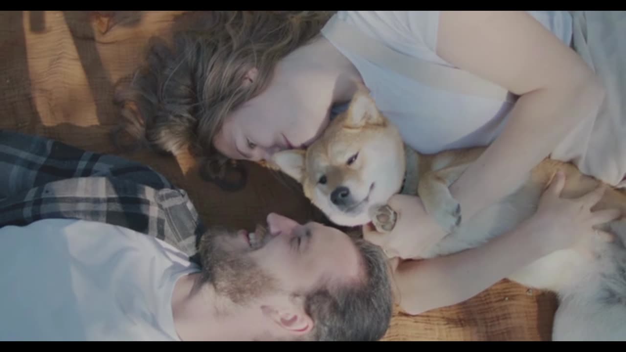 A Couple And Their Dog Having Fun Time