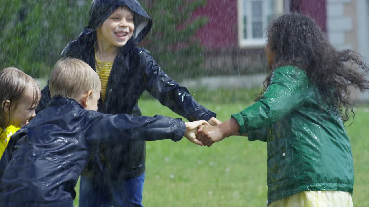 Children Playing In A Park Getting Wet By The Rain