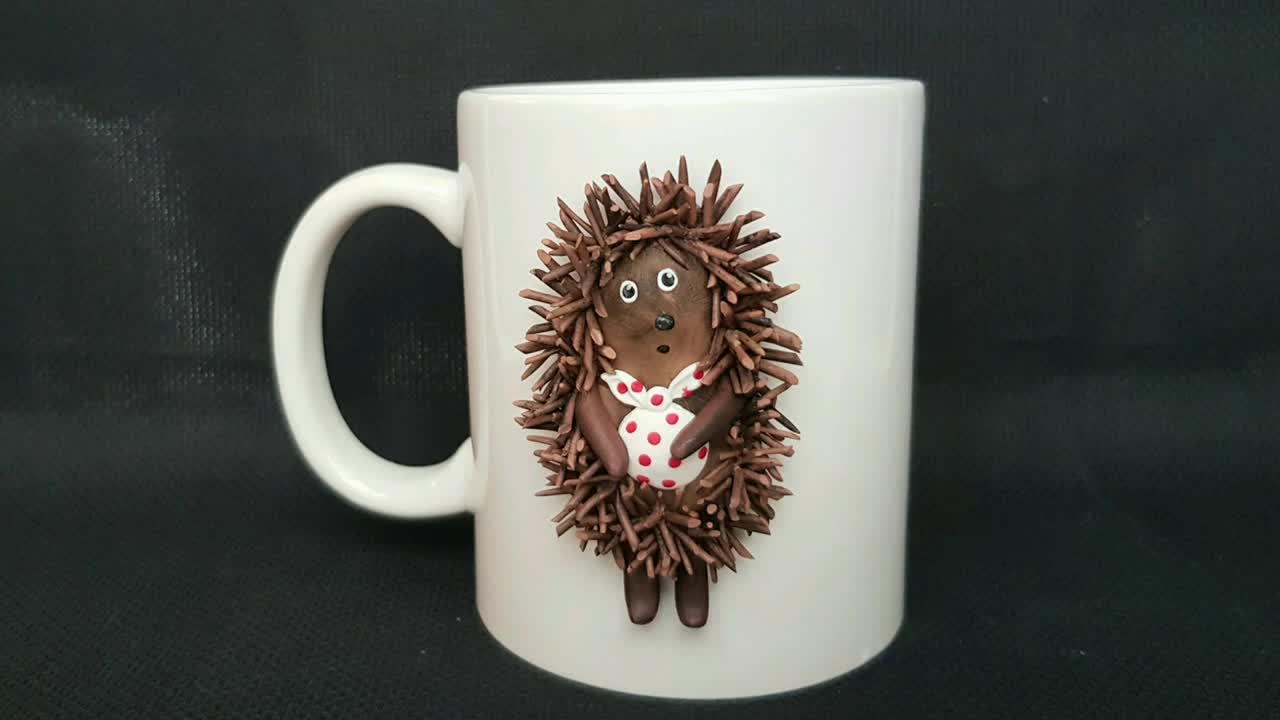 Mug with a hedgehog in the fog. Gift hedgehog made of polymer clay on a white cup AnneAlArt.