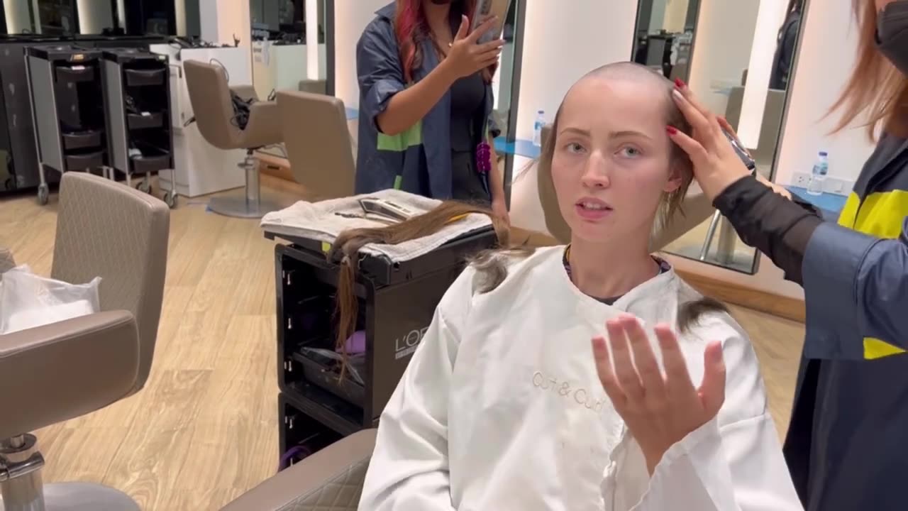 Woman self shave all her hair at salon