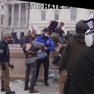 J6: cop passing out water to the crowd