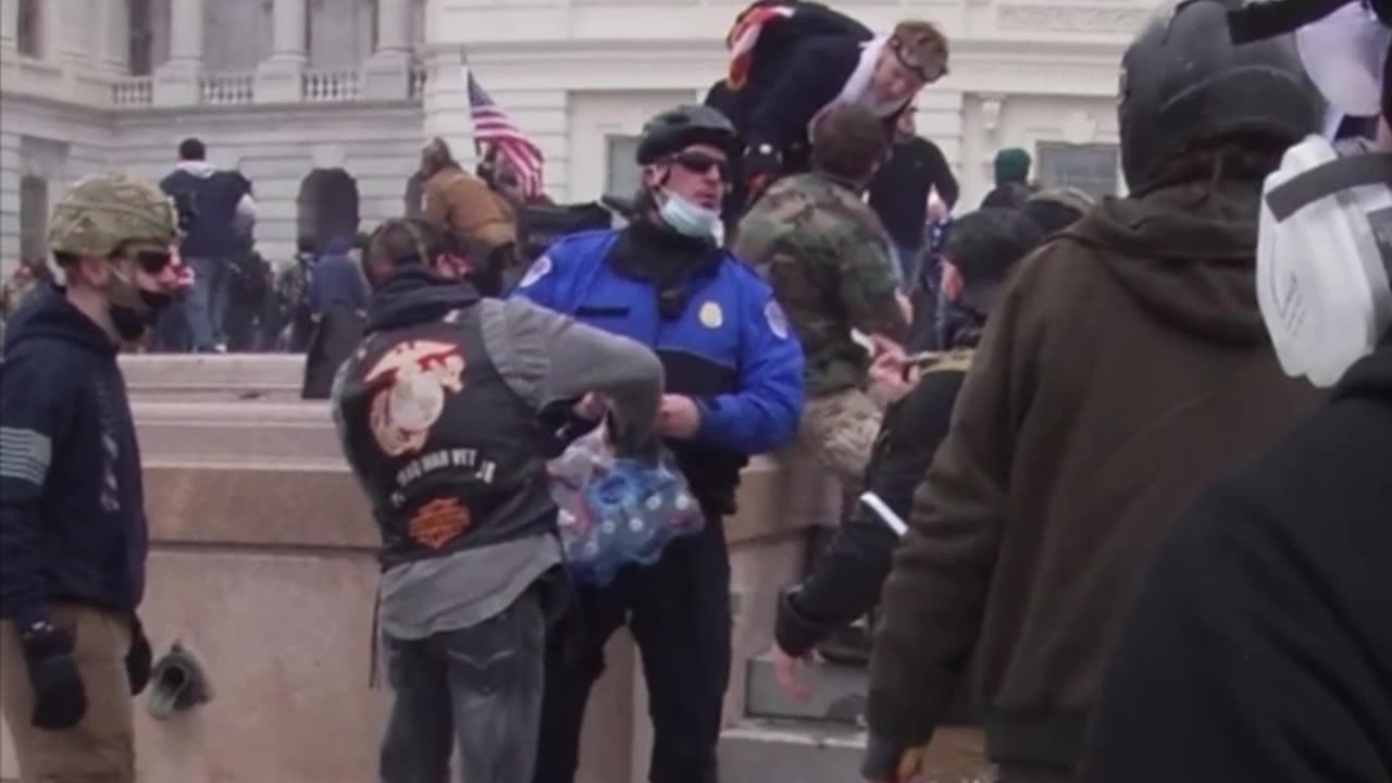 J6: cop passing out water to the crowd