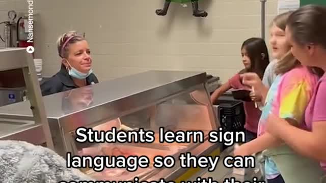 Students learn sign language so they can communicate with their deaf cafeteria worker