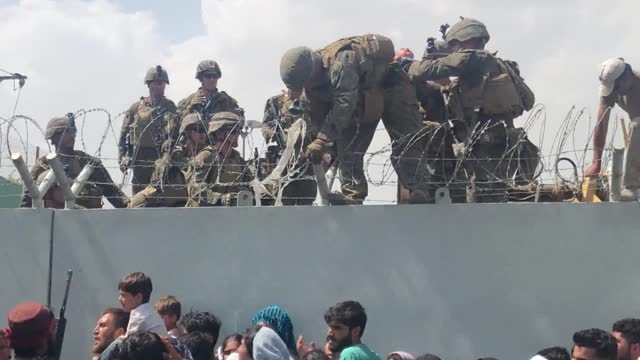 Afghan Infant Passed to Soldiers at Airport