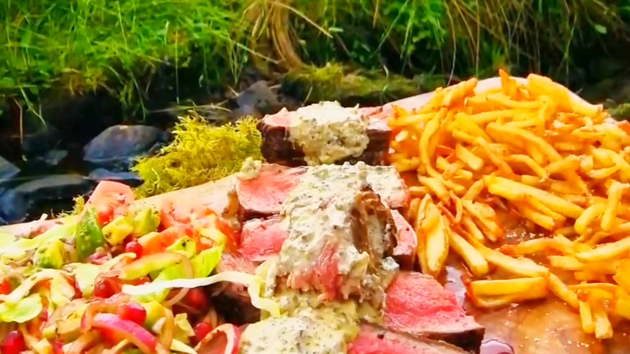 Tomahawk steak with potatoes and salad in the forest on a fire