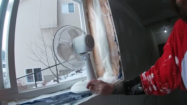 Fan in the Window to Remove Dust While Sanding Drywall