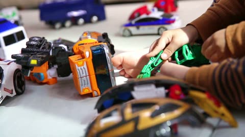 a child's hand playing with a robot toy