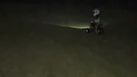 3 year old riding his xr50 with a headlamp