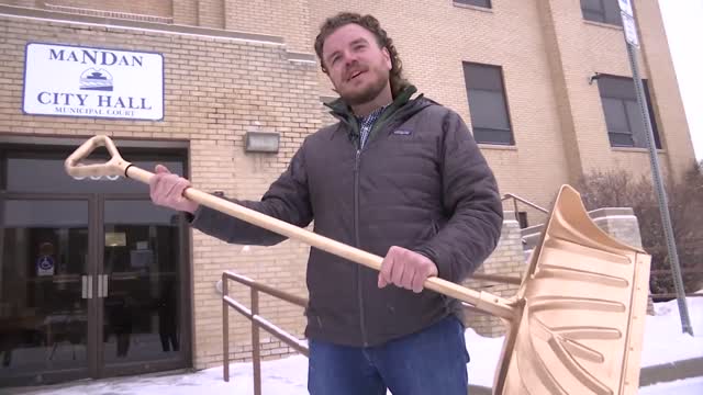 Mandan Business Shoveling Golden Shovel