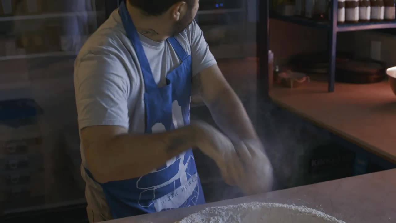 Baker preparing flour for dough or pizza