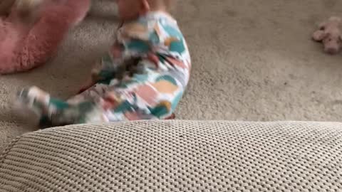 Baby Doing a Funky Move Falls on Squeaky Toy