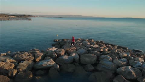 ws slo mo ts pov man walking on groyne rosignano livorno italy