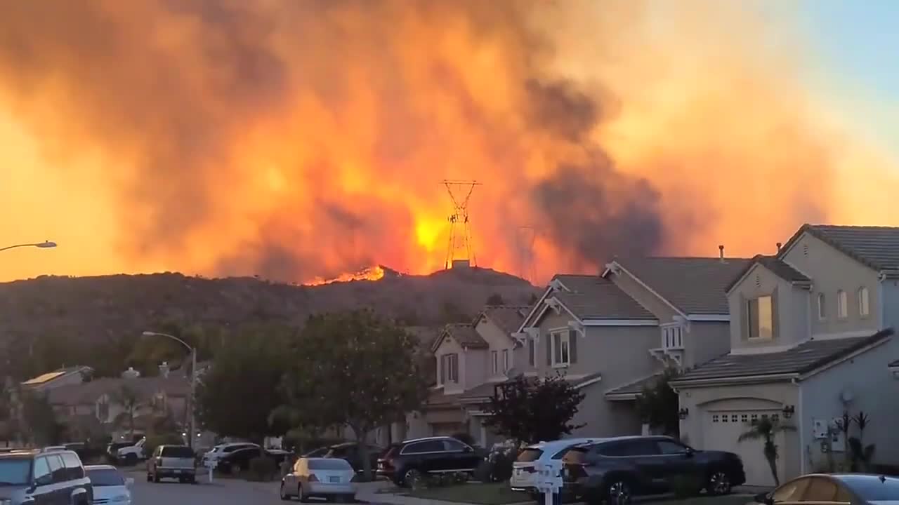 Smoke Engulfs Orange Sky As Wildfire Spreads Downhill in U.S. Neighborhood