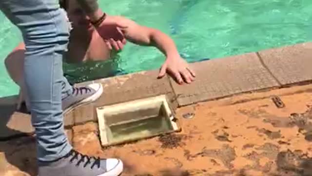 Man Stumbles and Falls Into Pool With Splash