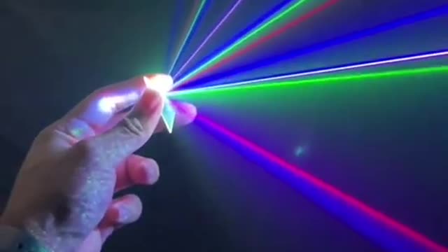 Broken Part of CD Reflects Multiple Colored Rays After Interacting With Concert Laser Beam