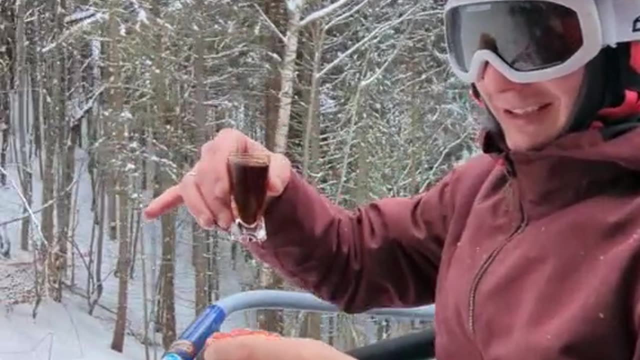 Skier Enjoys a Meal on Chairlift