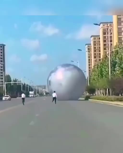 HILARIOUS MOON BALLOON IN CHINA ROLLING DOWN THE ROAD