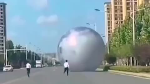 HILARIOUS MOON BALLOON IN CHINA ROLLING DOWN THE ROAD