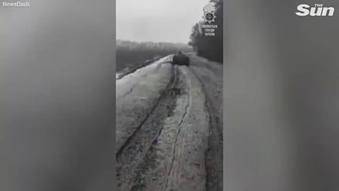 Ukrainians tow armoured vehicles through the mud using tanks in winter