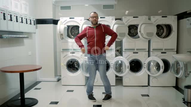 Man Dancing Swing And Have Fun In the Laundry Room. Happy Man Enjoying Dance, Having Fun Together.