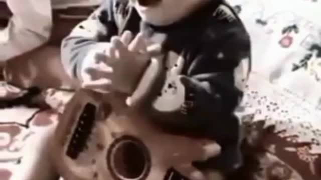 Funny baby with guitar