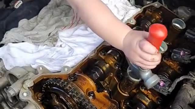 The little mechanic is working hard on the engine.