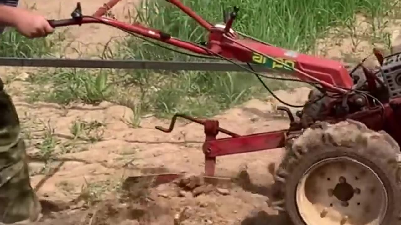 plowing the land with a mini tractor