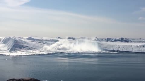 Ilulissat Icefjord - Large iceberg breaking over