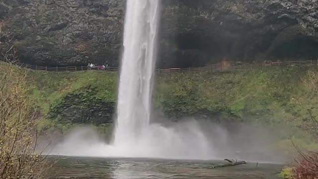 Close Up Of Water Cascading Off The Edge Of A Small Waterfall