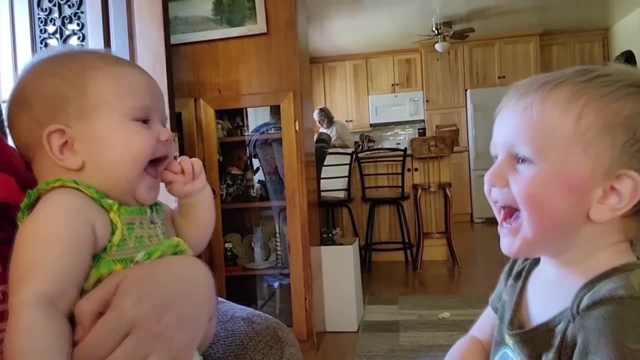 baby has fun with his older brother, cute and funny