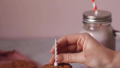 A Person Lighting a Candle on Top of the Cookie Sandwich