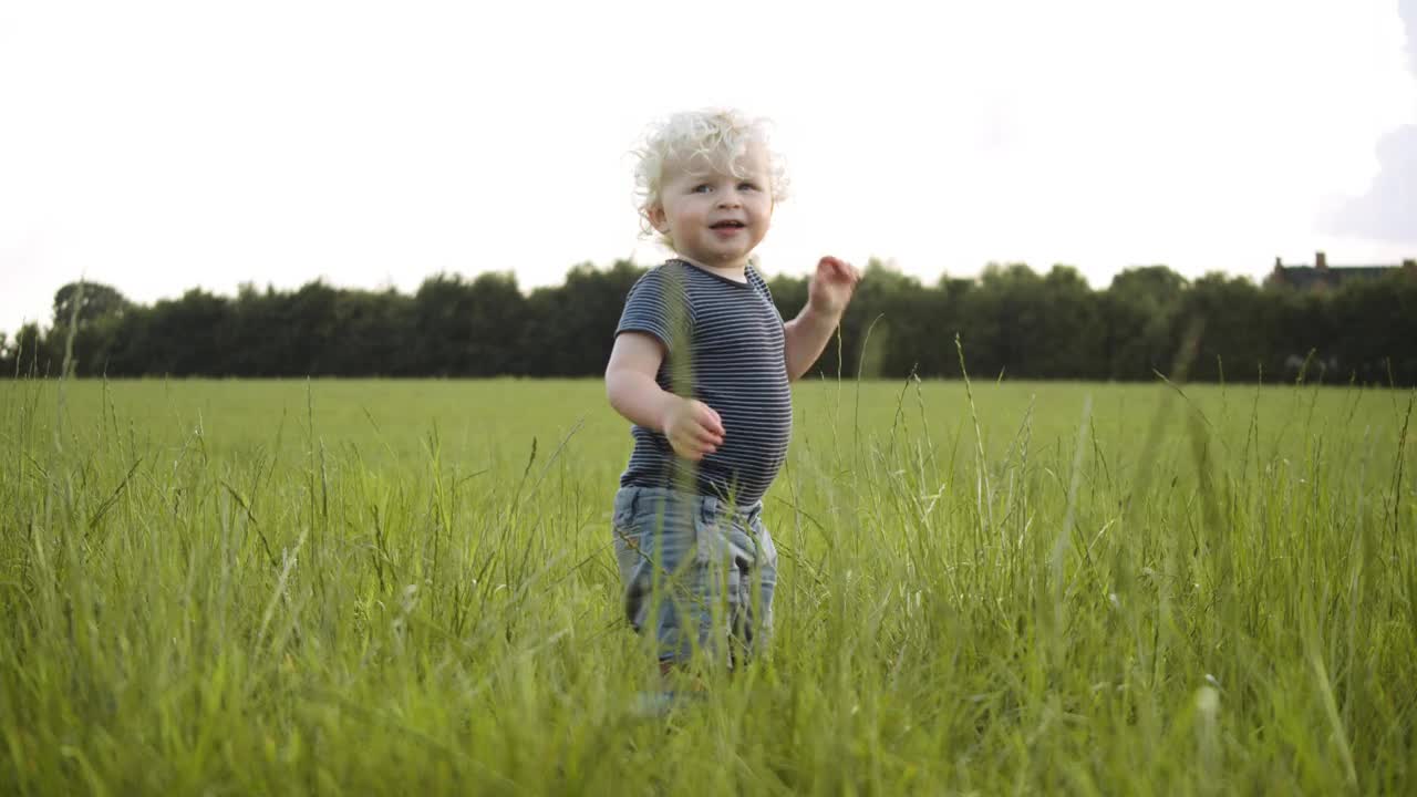 Toddler laughing outside