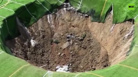 Moment massive sinkhole swallows soccer field in Alton, Illinois