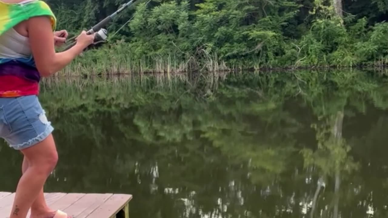 Woman Catches Catfish After It Takes Off With Her Fishing Pole