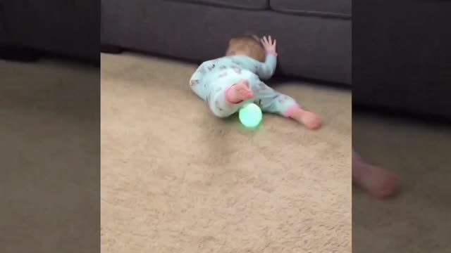 Baby playing with blowing ball.