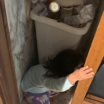 Baby found inside the cabinet with trashed
